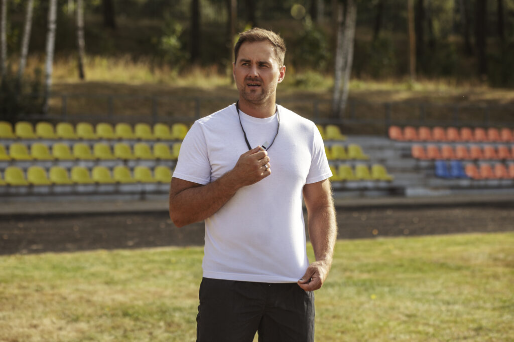 kids-playing-football-supervised-by-football-trainer